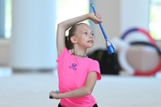 Young gymnast during an exercise with clubs