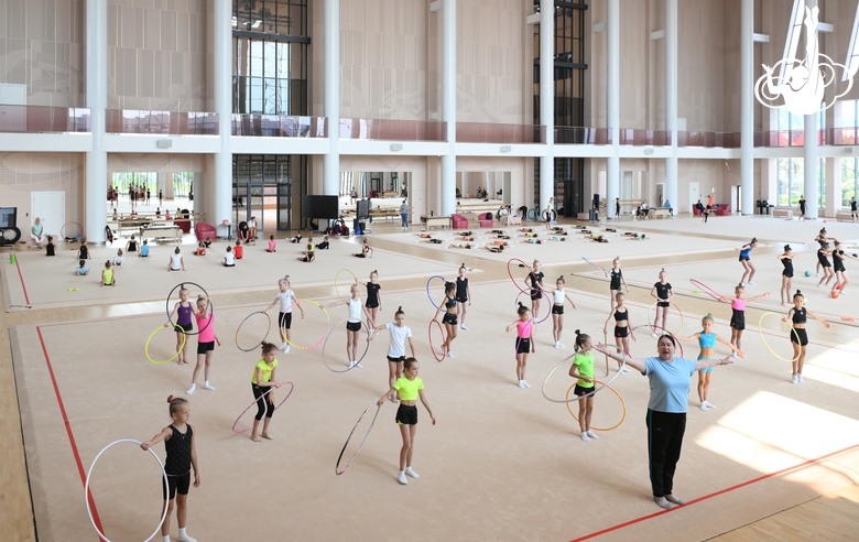 Gymnasts and coach Zlata Tulubaeva during practice at the training camp in the Academy