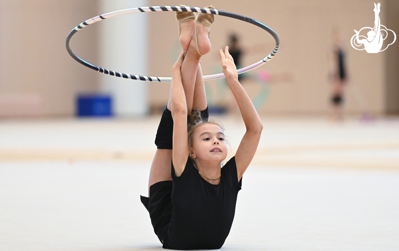 Elvira Belyaeva does the droplet element during the  exercise with a hoop