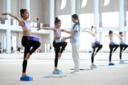 Academy Coach Elizaveta Chernova and gymnasts from China during the training session