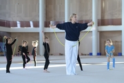 Academy Coach Anna Ustsova with young gymnasts during the exercise