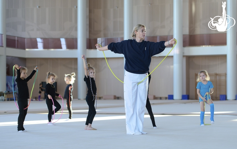 Academy Coach Anna Ustsova with young gymnasts during the exercise