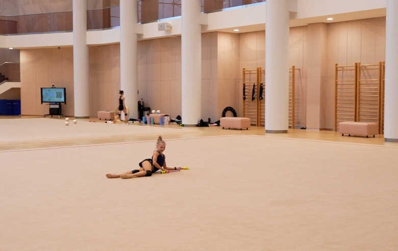 Eva Kononova works on her clubs routine and attempts the same elements in half-shoes given to her by Alina Kabaeva