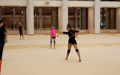 Alina Kabaeva and Irina Zenovka work with Mariia Borisova on the accent point in the ball exercise