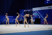 Group gymnasts during an exercise with hoops and clubs