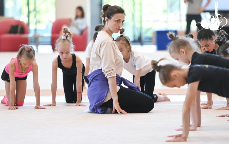 Coach Irina Dzyuba with young gymnasts during a training session