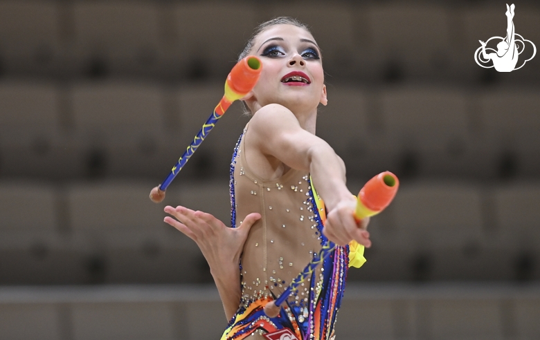 Gymnast during an exercise with clubs