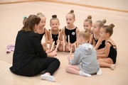 Teacher Anna Pukhova with young gymnasts during a rhythmics class