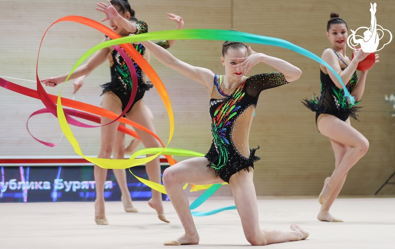 Gymnasts during an exercise with balls and ribbons