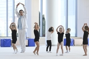 Academy coach Olesya Kovaleva with young gymnasts during training