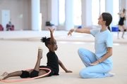 Academy coach Elizaveta Chernova with gymnast Nkenko Sita Davina Chanselvi during the training session