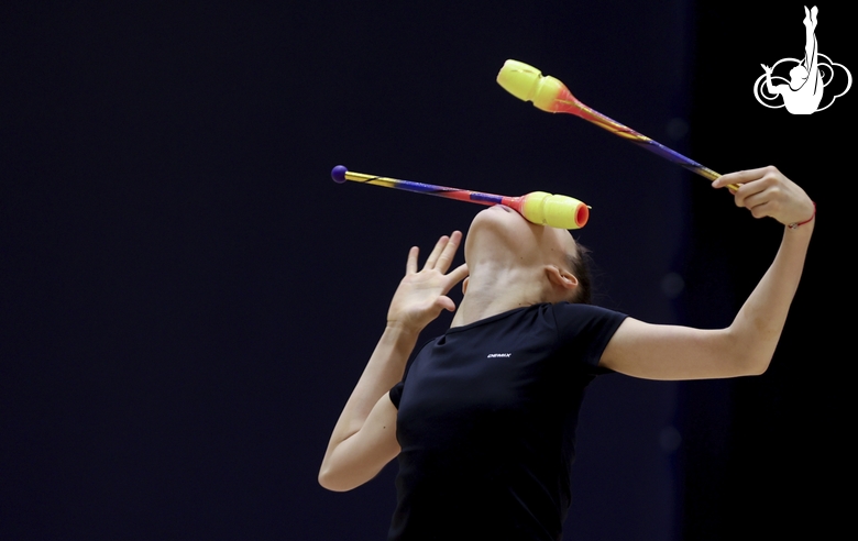 Gymnast during an exercise with clubs at floor testing