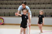 Academy trainer Elizaveta Chernova and a young gymnast during training