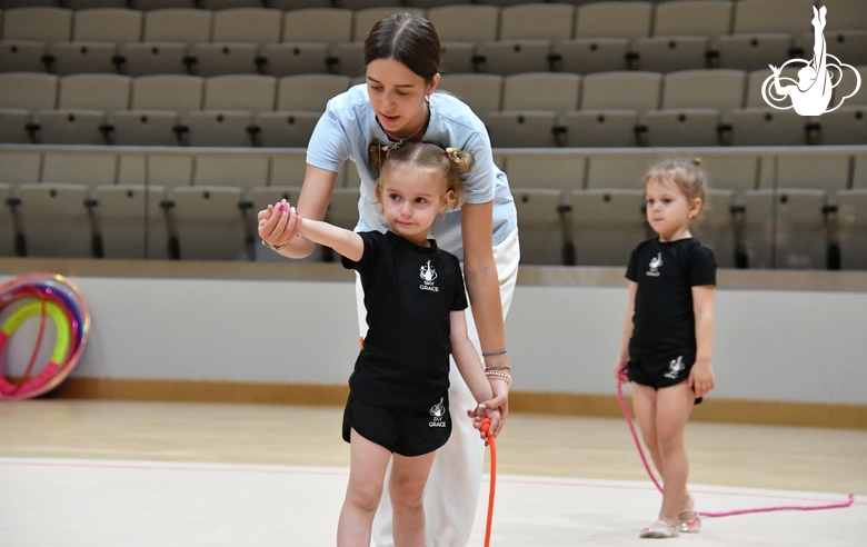 Academy trainer Elizaveta Chernova and a young gymnast during training