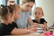 Academy coach Olga Frolova with young gymnasts during class  Young gymnasts during training