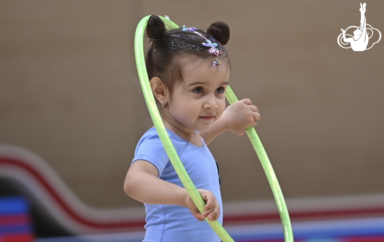 Young gymnast during an exercise with a hoop at the mAlinka tournament