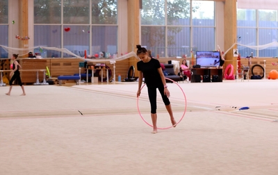 Mariia Borisova and Irina Zenovka are working on an exercise with a hoop in Novogorsk