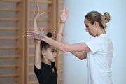 Coach Inna Zhukova and gymnasts during the training session