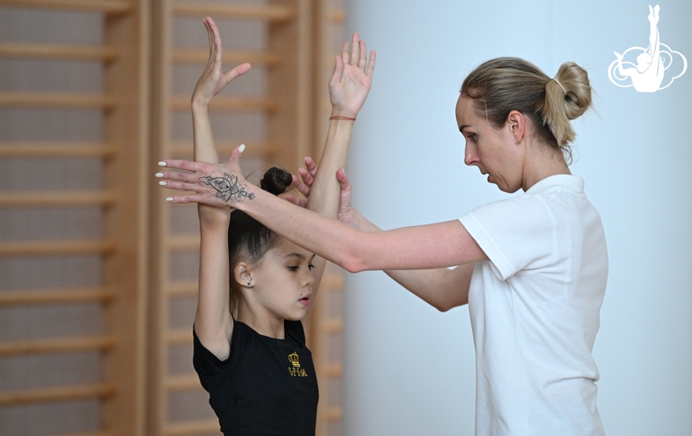 Coach Inna Zhukova and gymnasts during the training session