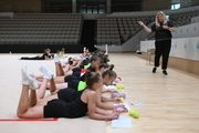 Psychologist Irina Kozyr with gymnasts during practice at the training camp in the Academy