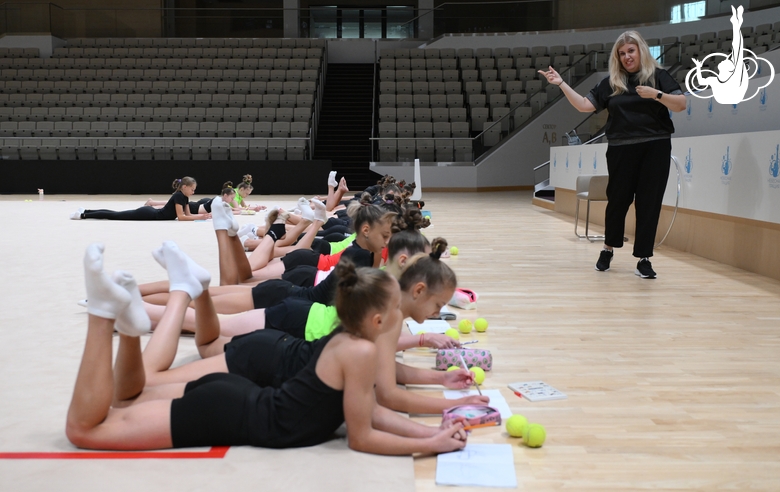 Psychologist Irina Kozyr with gymnasts during practice at the training camp in the Academy