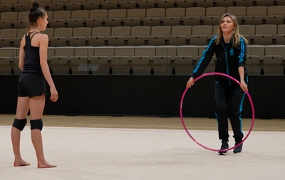 Olympic champion Alina Kabaeva shows Masha Borisova how to catch a hoop with greater ease and have it look more interesting