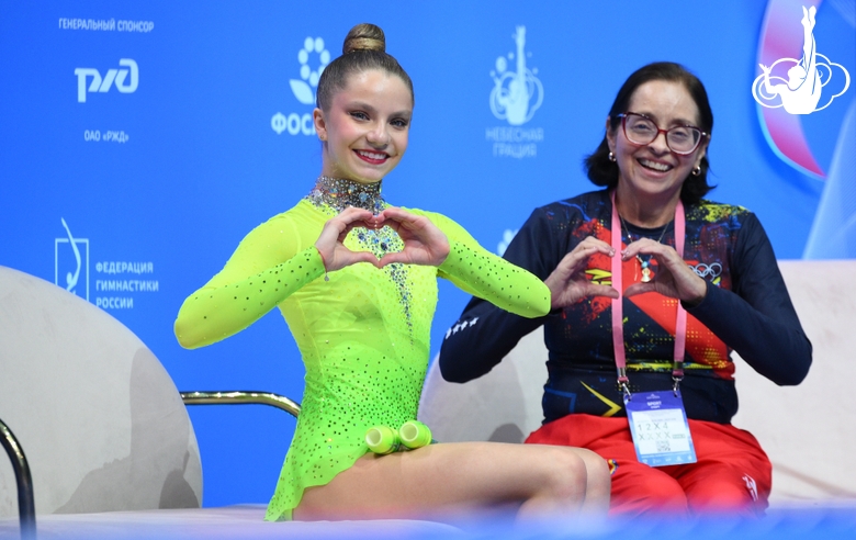 Jimena Dominguez with coach during an exercise with clubs
