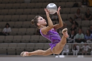 Gymnast does an exercise with a ball during a performance at Formula of Victory competition