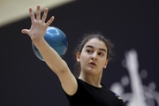 Gymnast during an exercise with a ball at floor testing