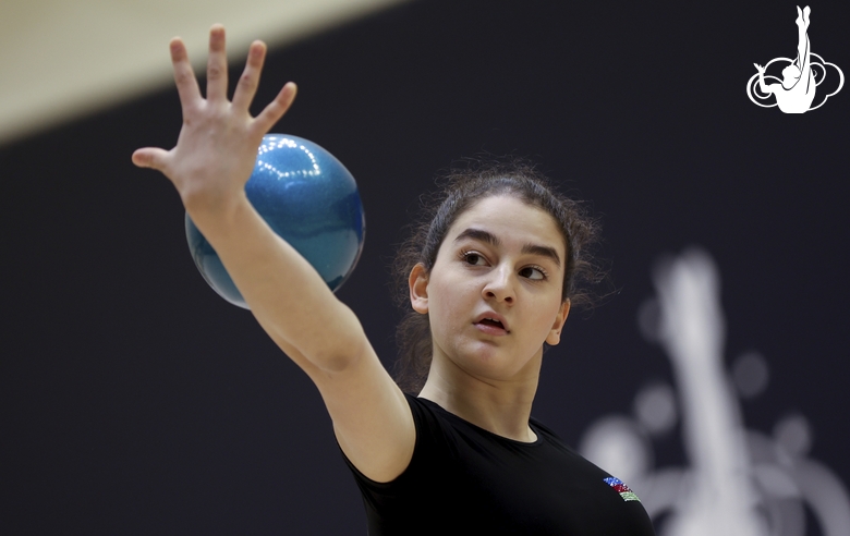 Gymnast during an exercise with a ball at floor testing