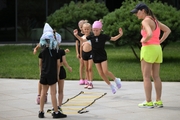 Academy coach Olesya Kovaleva and young gymnasts during training