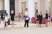 Academy coach Irina Dzyuba with gymnasts during class