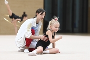 Academy coach Elizaveta Chernova with a young gymnast