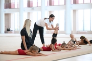 Coaches Elizaveta Chernova, Elizaveta Zorkina and young gymnasts during training