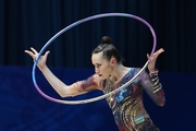 Takhmina Ikromova during an exercise with hoop