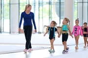 Coach Elizaveta Zorkina and young gymnasts during training
