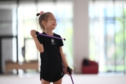 Young gymnast performing a club routine