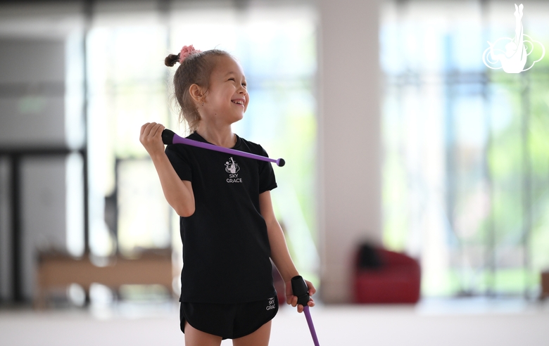 Young gymnast performing a club routine