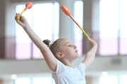 Gymnast during an exercise with clubs