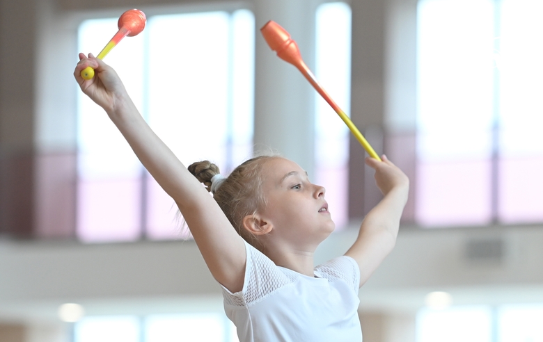 Gymnast during an exercise with clubs