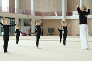 Academy Coach Anna Ustsova with young gymnasts during the exercise