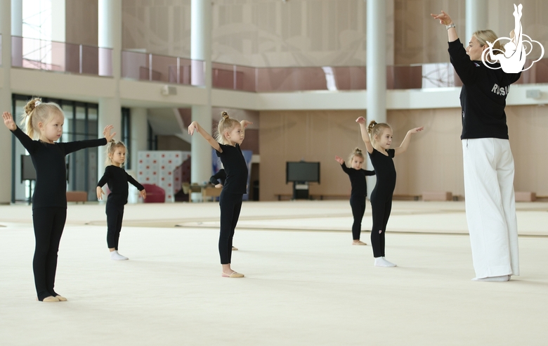 Academy Coach Anna Ustsova with young gymnasts during the exercise