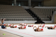 A gymnast with a coach during the training session