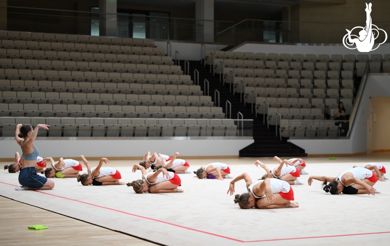 A gymnast with a coach during the training session