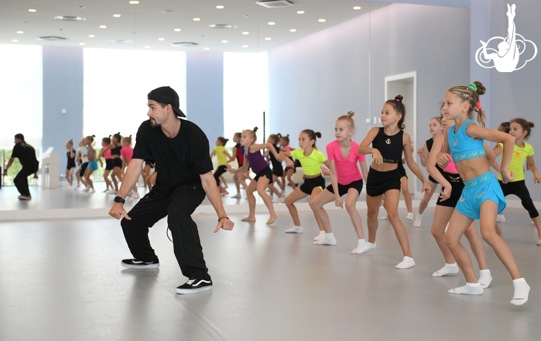 Choreographer Artur Nureev with gymnasts during practice at the training camp in the Academy