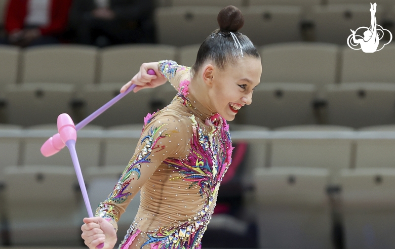 Gymnast during an exercise with clubs