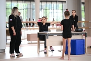 Academy coach Evgeniy Eliseeva, Dina and Arina Averina with Diana Solosina during training