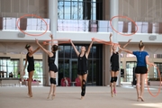 Gymnasts performing an exercise with hoops