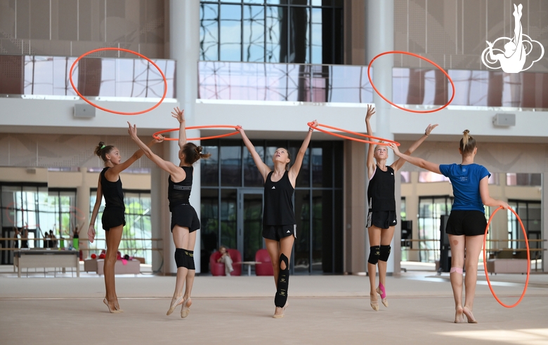 Gymnasts performing an exercise with hoops