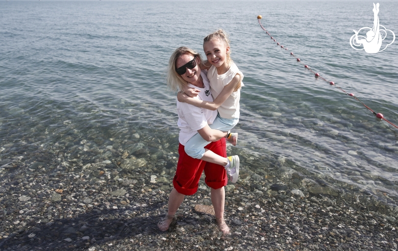 Coach Elena Berkova with a gymnast on the beach